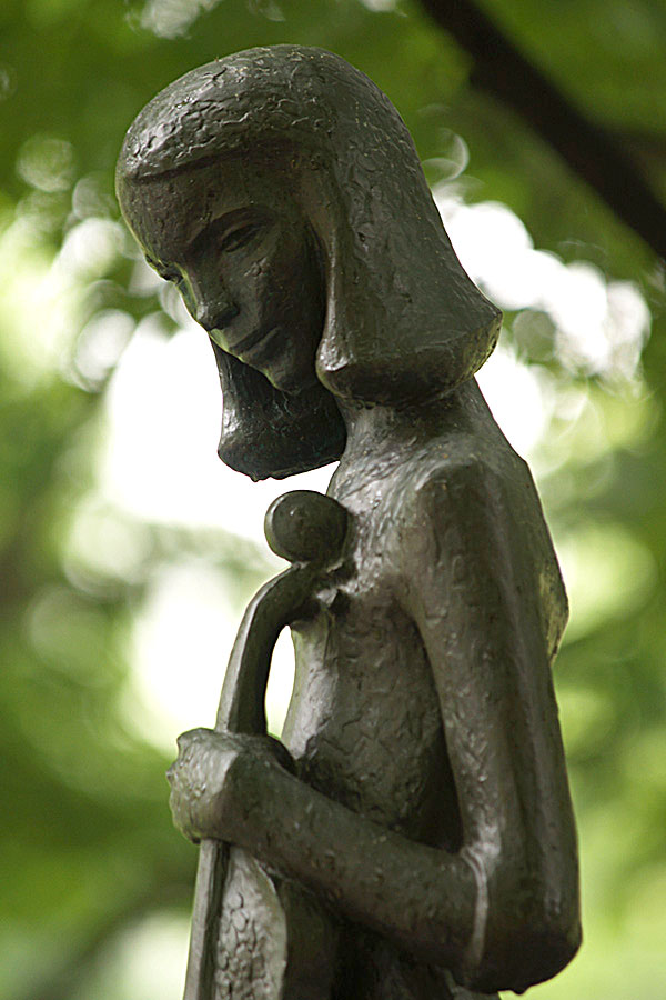 cast bronze sculpture depicting a girl with a violin